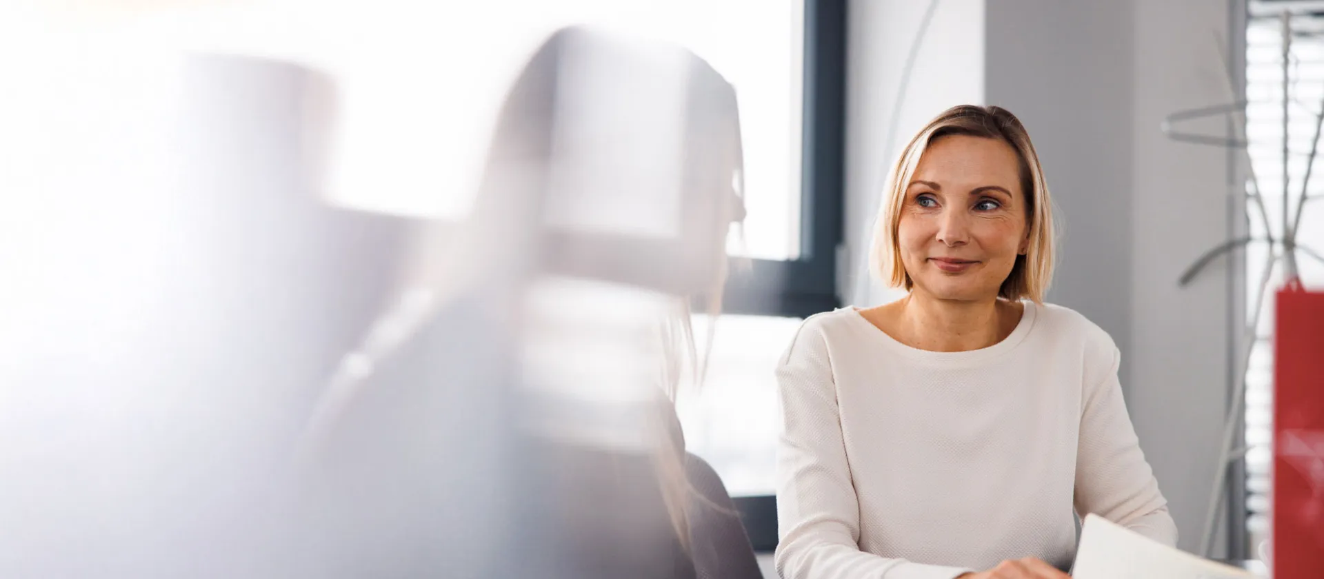 Professional businesswoman during a meeting, symbolizing collaboration, leadership, and strategic thinking in a modern office environment.